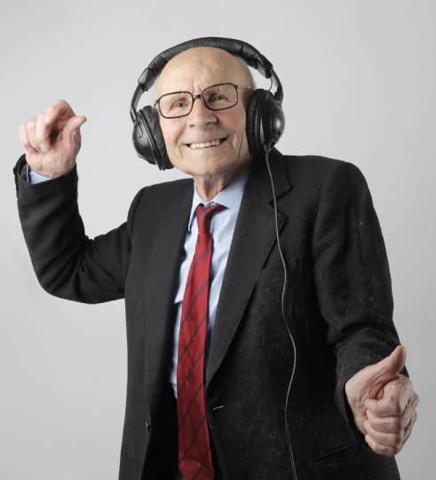 Old man listening to music while smiling