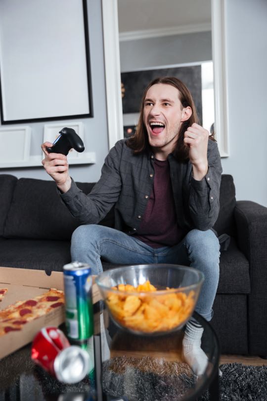 Excited man playing video games