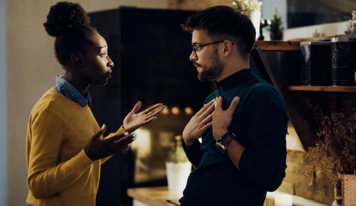 Young couple with relationship difficulties arguing at home